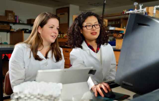 Two graduate students on the Flint Michigan Water Study team in the lab