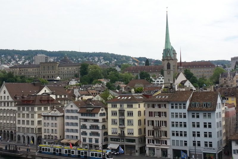 A photo of a church spire above a town in Switzerland