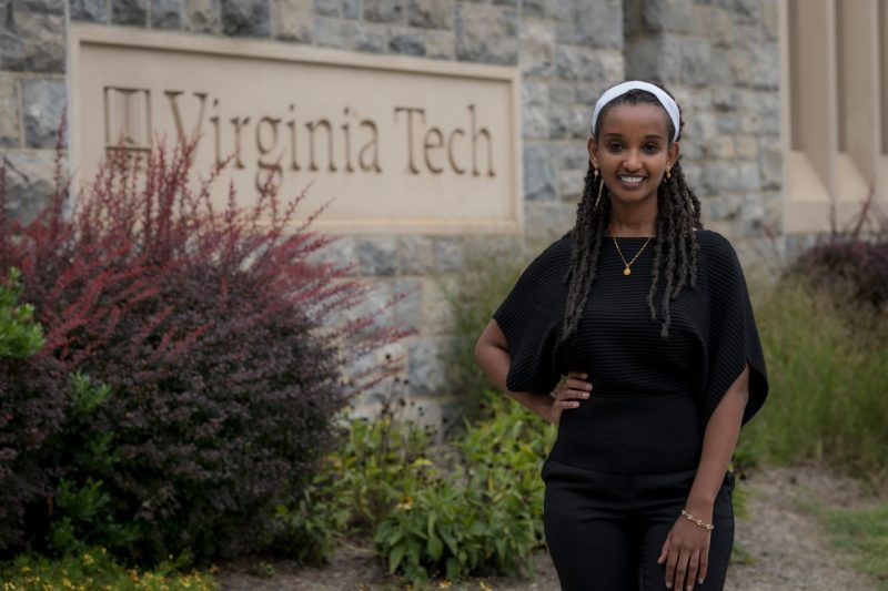 Maedot Haymete, a first year student at the Virginia Tech Carilion School of Medicine, stands outside the school's building made of Hokie Stone.