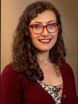 Assistant Professor Sarah Misyak, wearing glasses, smiling