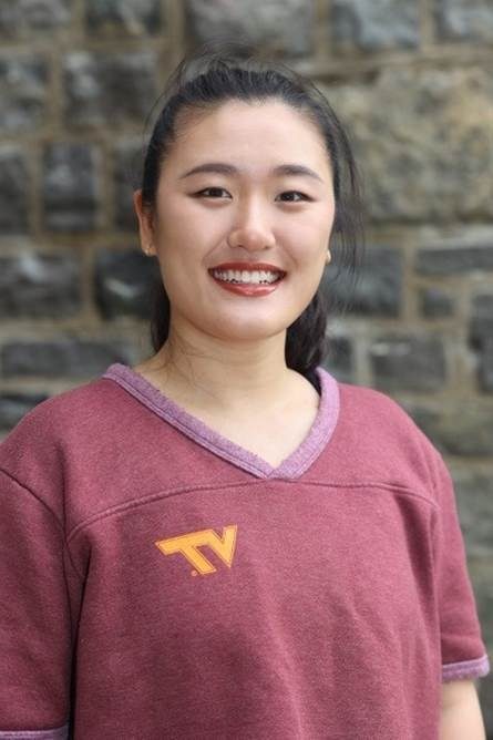 Tian Meng smiling and wearing a VT T-shirt