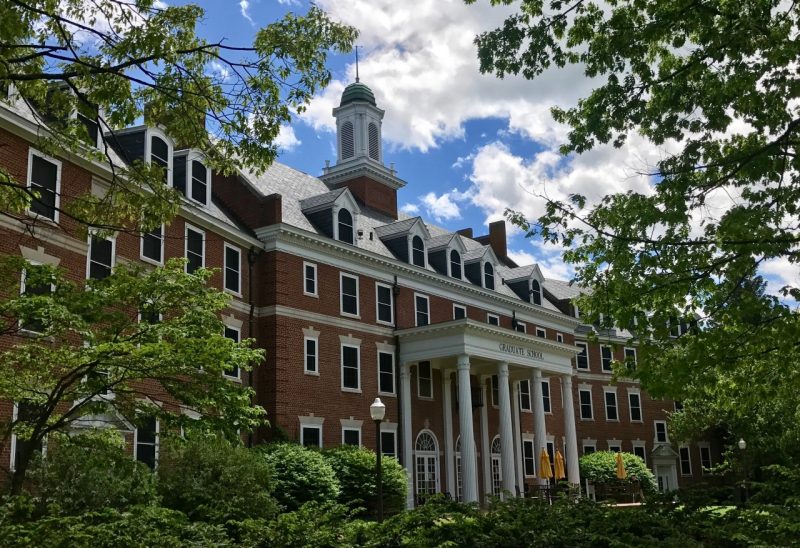 Graduate Life Center in Spring photo of the Alumni Hall GLC entrance as seen through trees in the spring